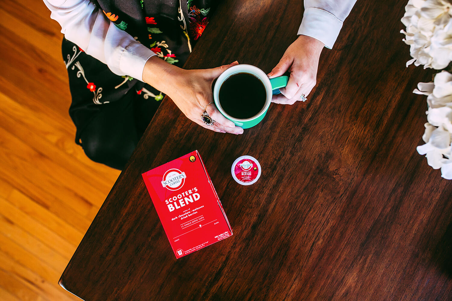 Single serve coffee box on table next to cup of coffee