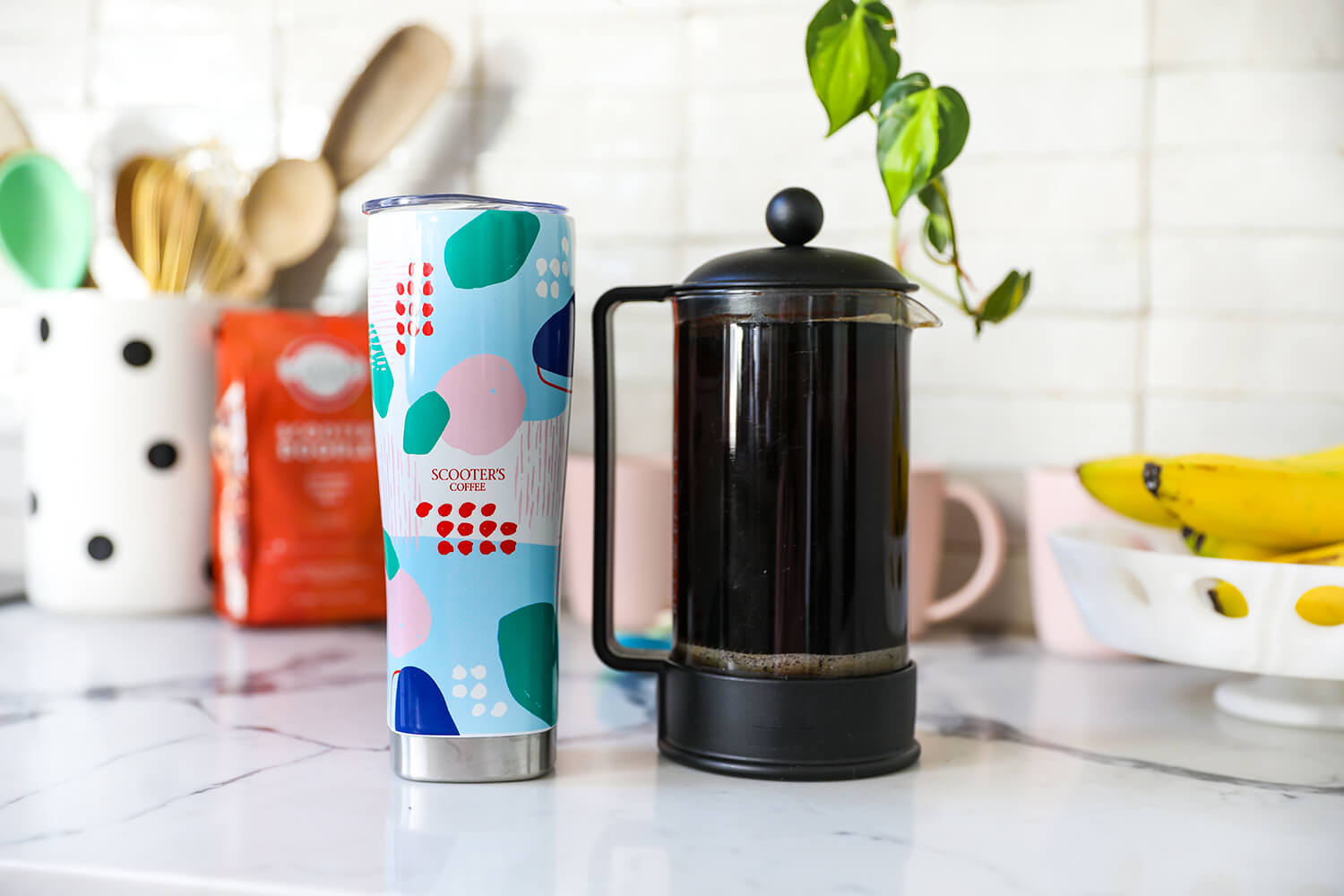 Tumbler next to pot of coffee