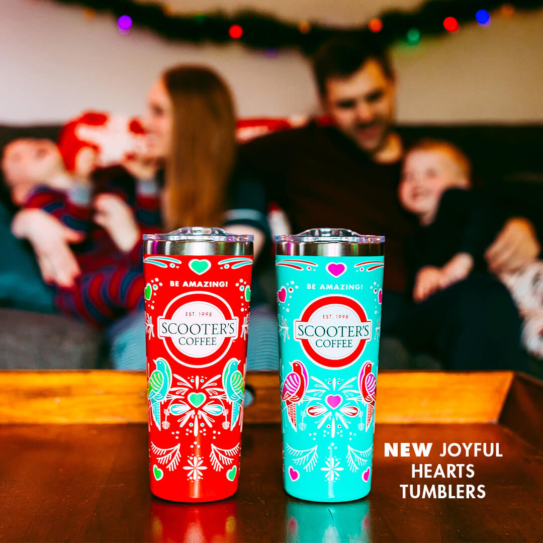 Two colorful tumblers on table in front of family