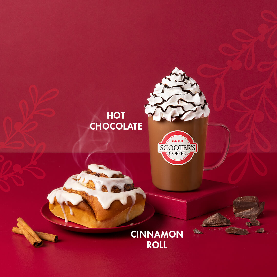 Hot chocolate and cinnamon roll on red background