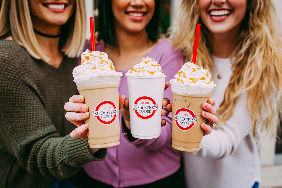 Three women holding coffee