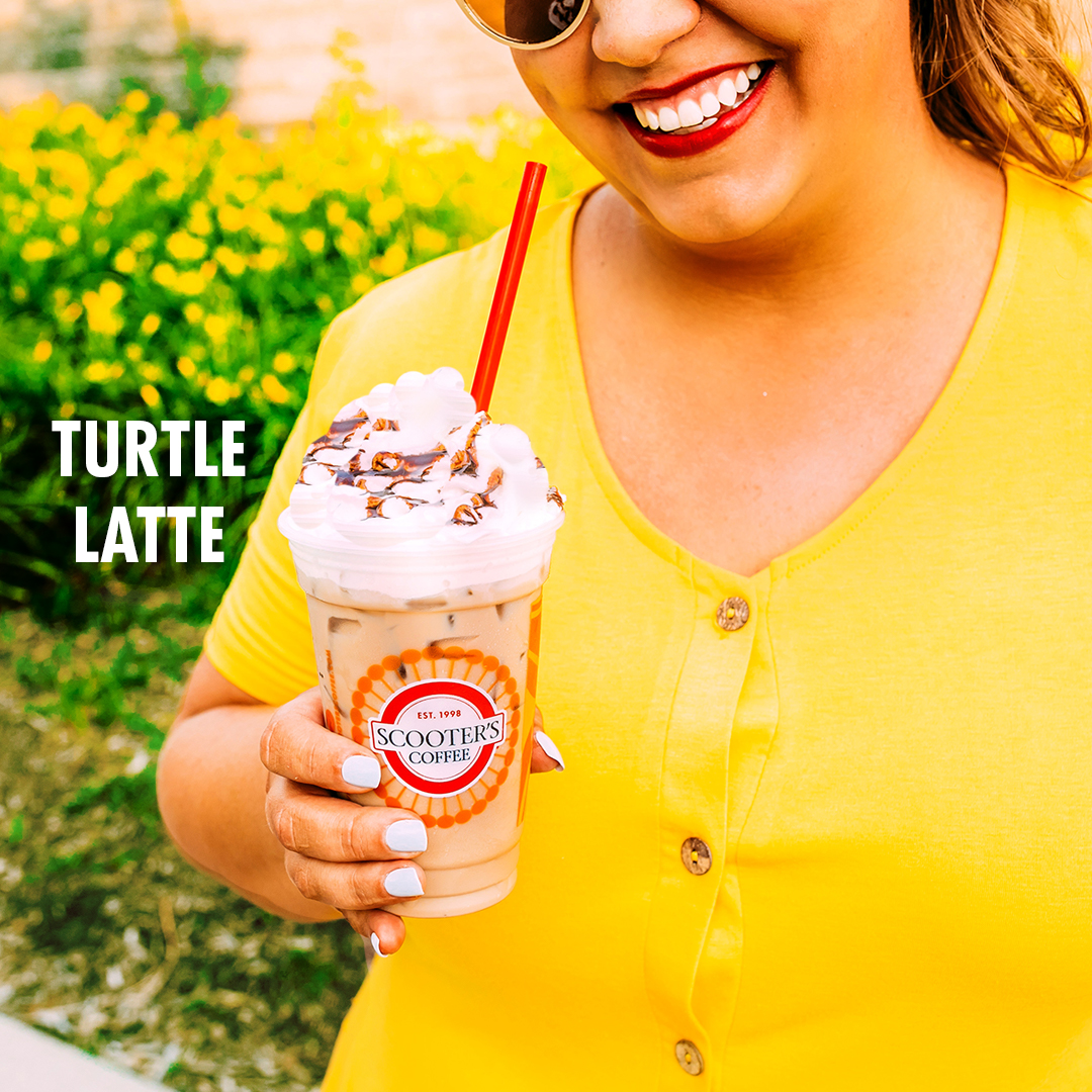 Woman smiling holding drink