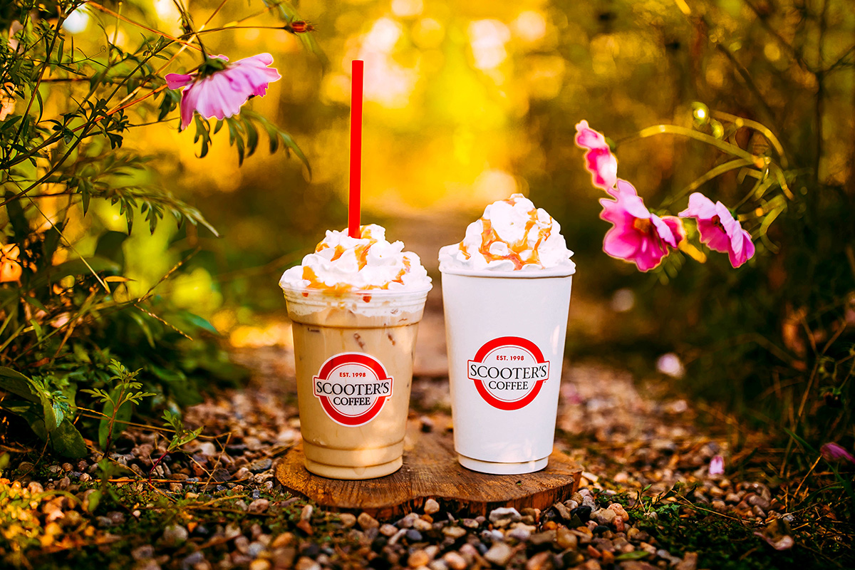 Hot and iced drink on ground by flowers