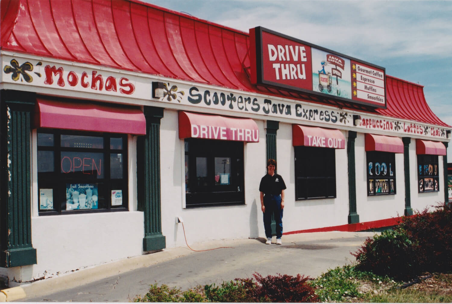 Linda standing outside Scooter's Coffee location