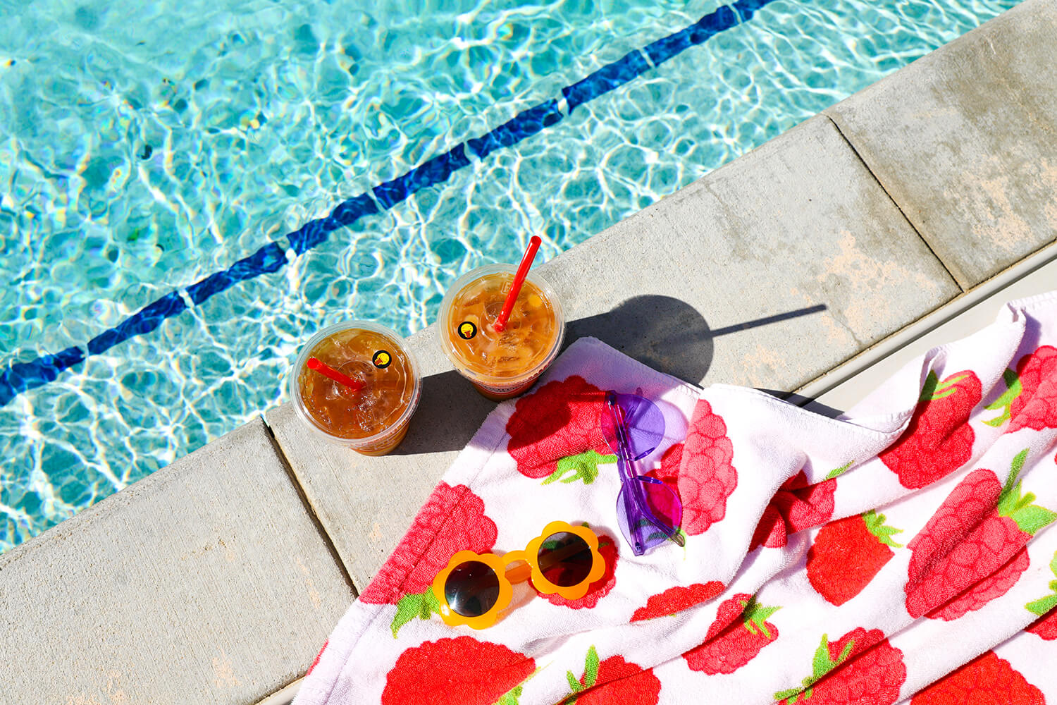 Top down shot of coffee drinks near swimming pool