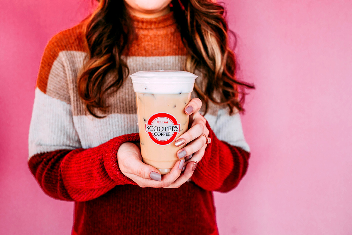 Woman holding iced coffee drink